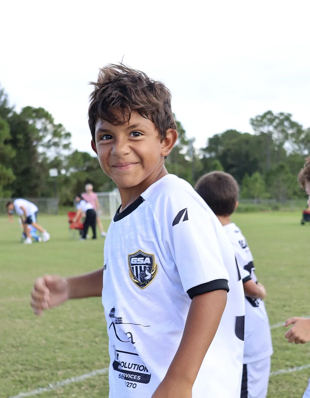 Young Galo player smiling at practice